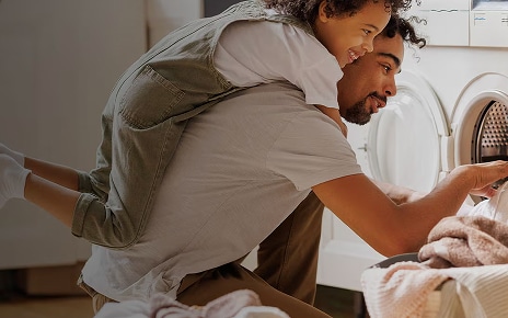 Father and child doing laundry together.