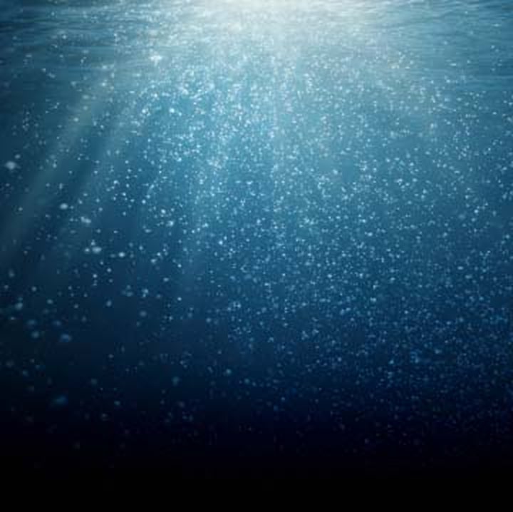Sunlight filtering through deep blue ocean water
