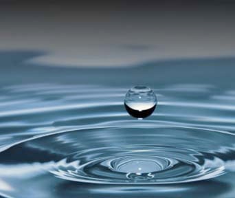 Water droplet creating ripples on the surface