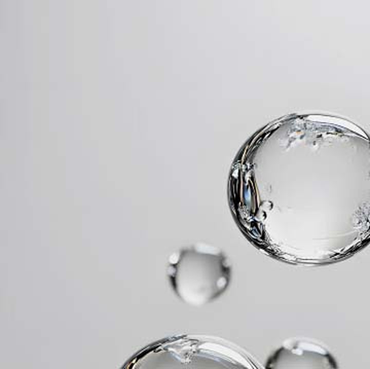Transparent floating bubbles on light gray background