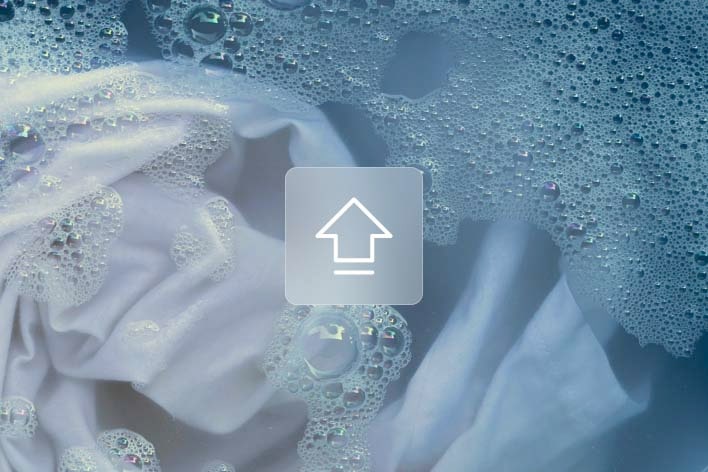 White fabric with soap bubbles in water