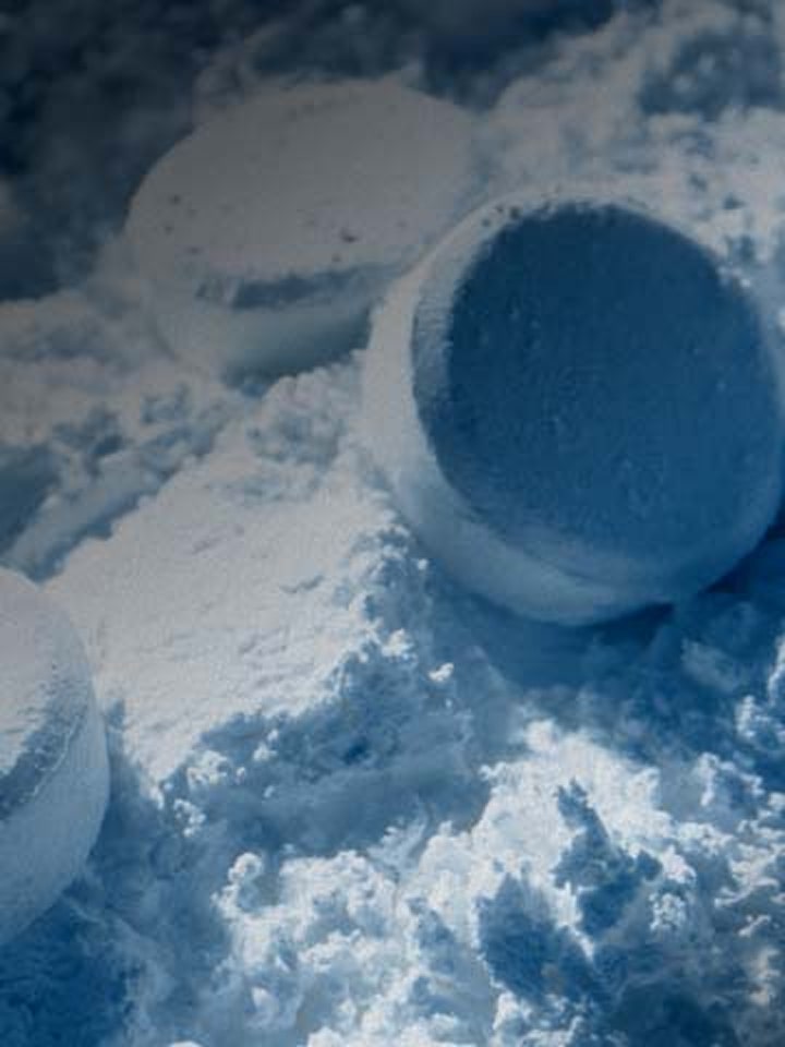 Close-up of white powder with overlay images showing a molecular structure and colorful plastic pellets.