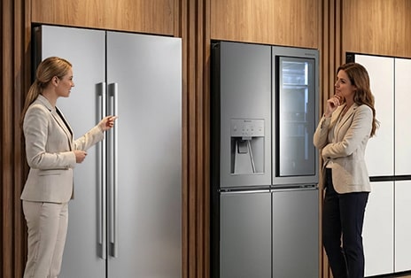 Two professionals reviewing an LG refrigerator, showing portfolio flexibility for residential developer projects.