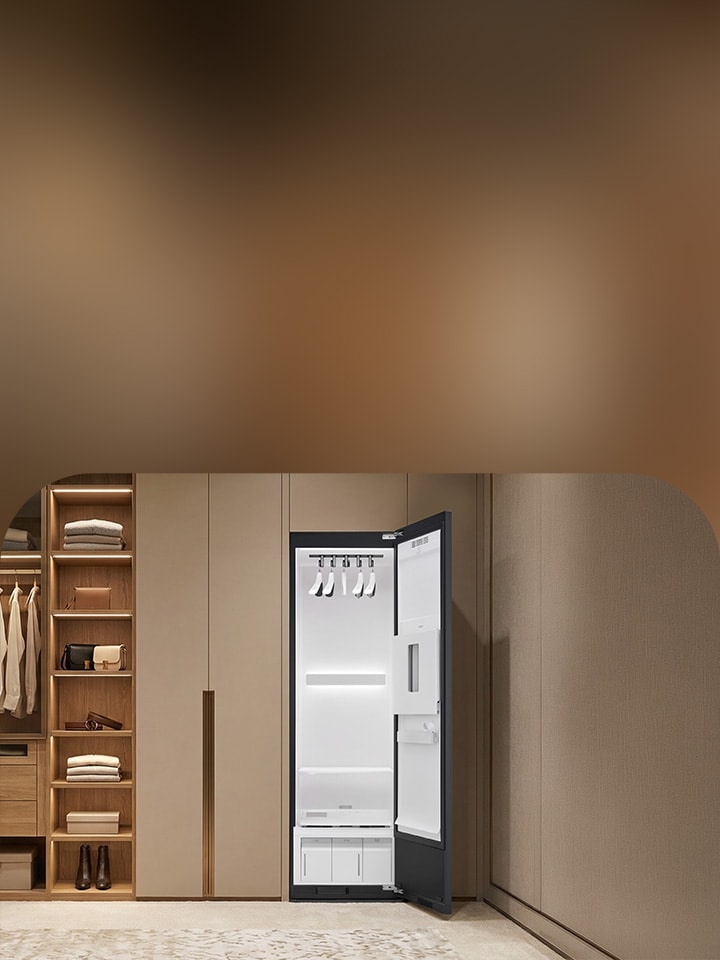Luxury walk-in closet with organized wood shelving and open LG Styler steam clothing care cabinet in a premium dressing room