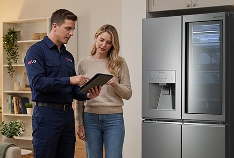LG technician and resident beside a refrigerator, representing warranty coverage and post-handover product support.