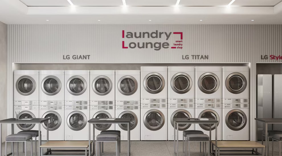 LG Laundry Lounge with rows of stacked LG Giant and LG Titan commercial washers and dryers, tables and chairs arranged for customers