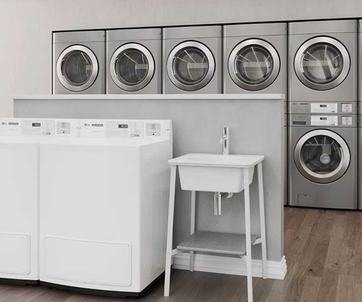 Laundromat with LG commercial washers and dryers arranged in rows with sink