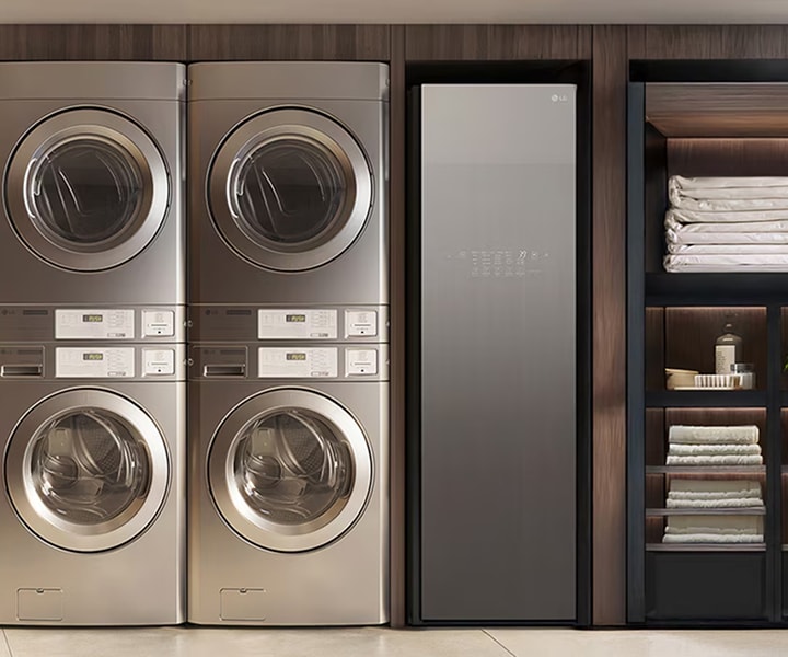 LG Smart Laundry Lounge with stacked commercial washers, dryers, and wardrobe-style appliance