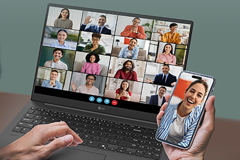A laptop displaying a video conference with multiple participants on the screen, accompanied by a smartphone showing an individual participant in the same call. This setup emphasizes seamless connectivity and multitasking for virtual meetings.