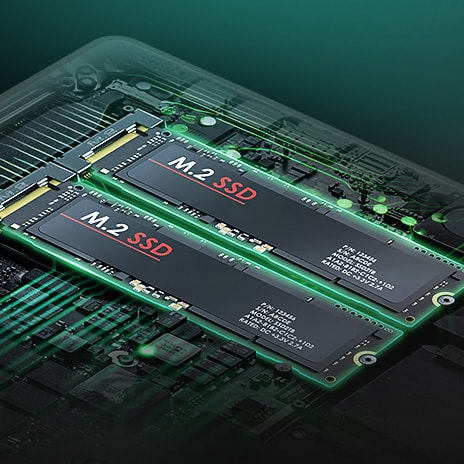 The image highlights the laptop's internal hardware, showcasing two M.2 SSDs installed side by side on the motherboard. The components are illuminated with a green glow, emphasizing the dual SSD configuration.