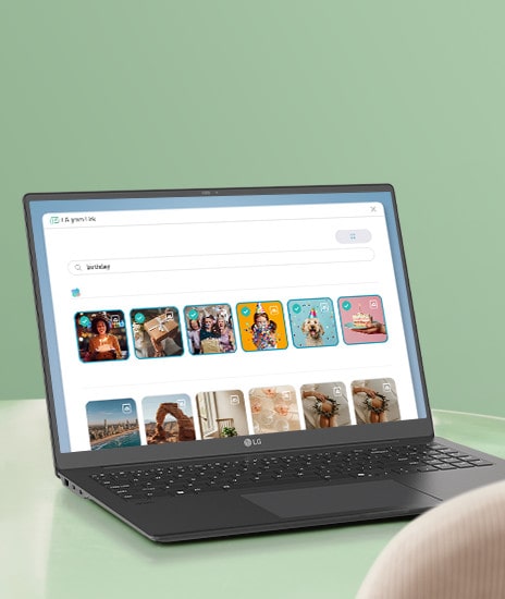 This image shows a laptop displaying a search interface for photos with the keyword 'birthday.' The screen features a grid of colorful photo thumbnails, each tagged with icons, indicating categorized or filtered search results.