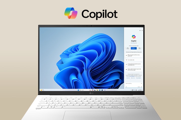 A laptop featuring the Windows Copilot logo above the screen and Windows Copilot interface on the display, showcasing a sleek design with a large screen and the Windows 11 interface in the background.