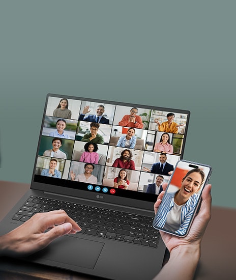 A laptop displaying a video conference with multiple participants on the screen, accompanied by a smartphone showing an individual participant in the same call. This setup emphasizes seamless connectivity and multitasking for virtual meetings.