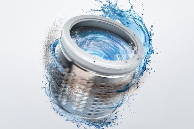 A washing machine drum spinning rapidly with water and detergent swirling around it. Dirt and debris are visible at the bottom of the drum.