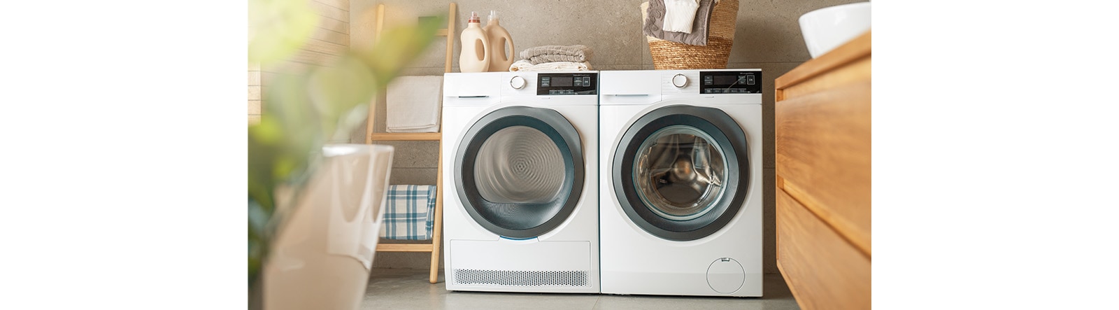 A picture with two white washing machines.