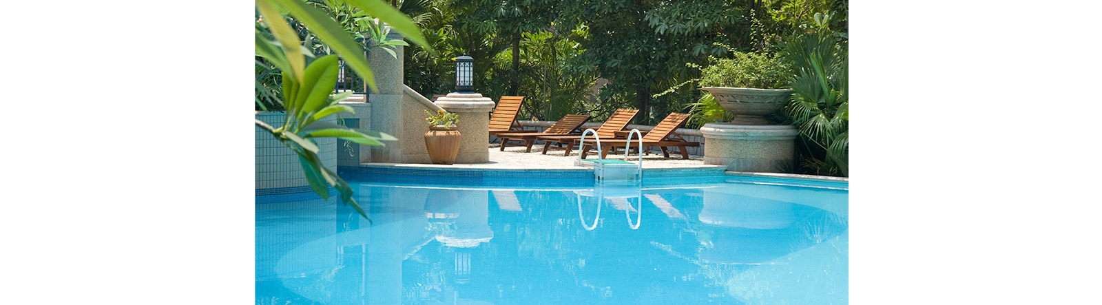 four chaise longues are located near swimming pool