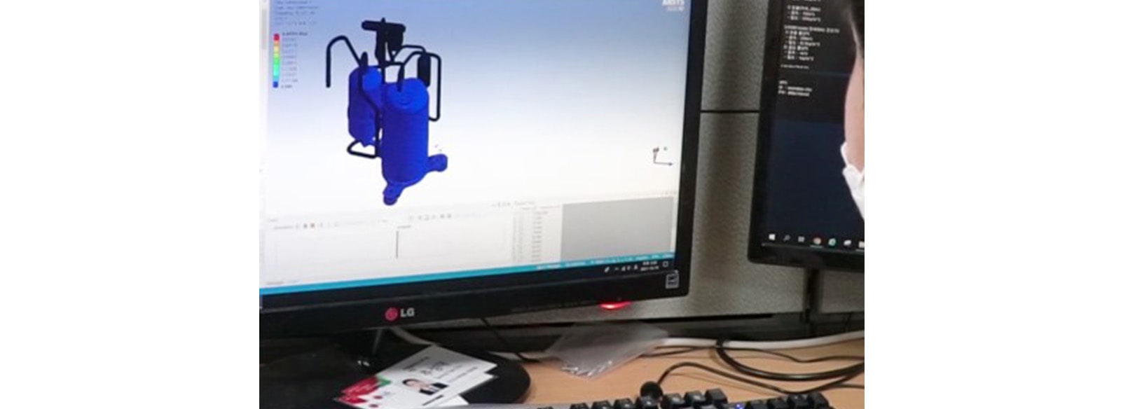 A CAE team member is looking at the monitor and working on simulation method of a compressor.