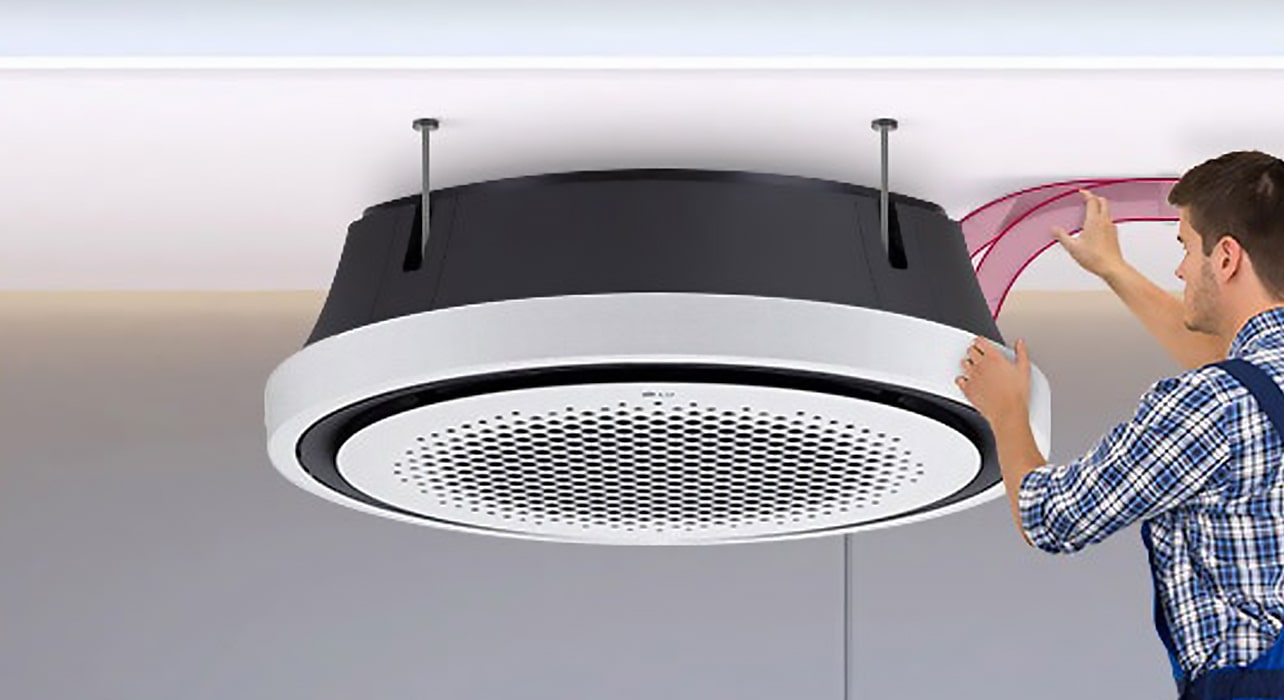 Technician installing an LG Round Cassette air conditioning unit on the ceiling, highlighting user-friendly maintenance and efficient piping design. Demonstrates LG’s innovation in installation and HVAC convenience