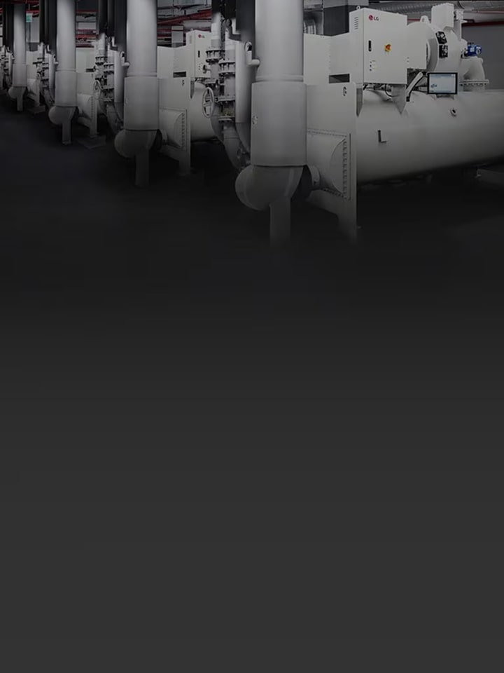 Multiple LG chiller units are installed in a spacious industrial facility with exposed piping.