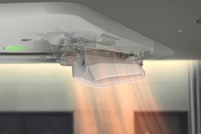 The solid white part of the dual vane distributes slightly red airflow directly toward two individuals positioned below it.