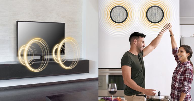 A TV is making sounds in one space, and a man and a woman are listening the sound of TV through external speakers in another space.
