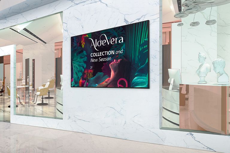 Signage installed on the interior walls of the shopping mall displays advertisements vividly.	