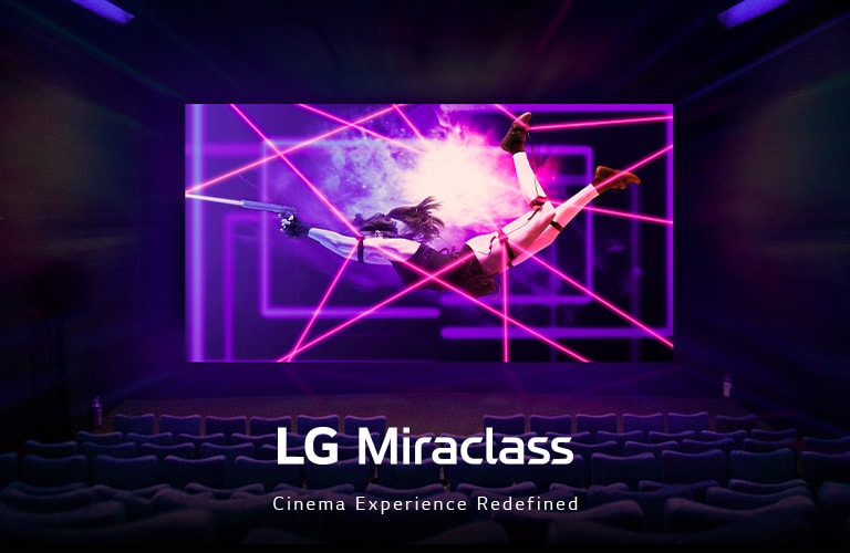 A large LED screen is showing a colorful and lively action scene at the movie theater.