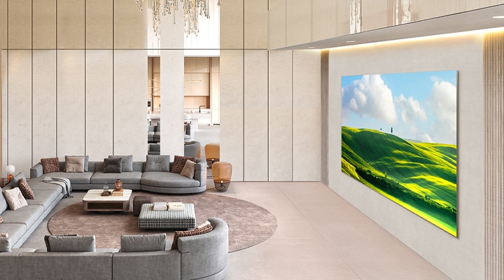 LG MAGNIT Active Micro LED is grandly installed in a high-ceiling, luxurious living room, displaying vivid natural scenery on its screen.