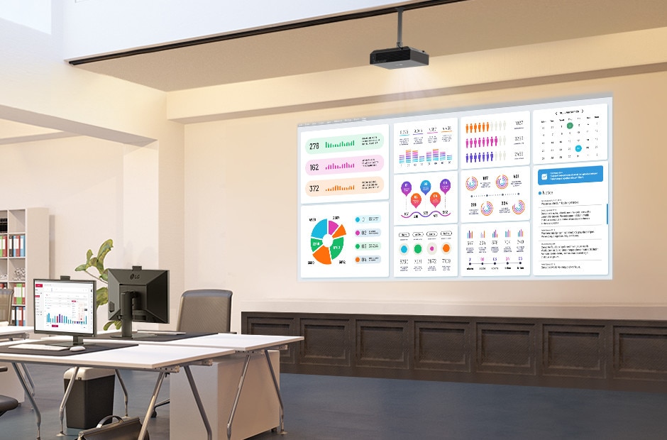 A ceiling-mounted projector in the office is projecting a beam, showing various charts. A ceiling-mounted projector in the office is projecting a beam, showing various charts.