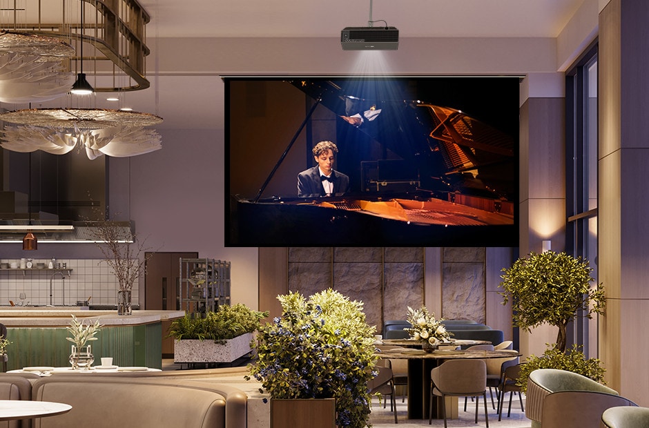 A projector is mounted on the restaurant ceiling, displaying a video of a man playing the piano. A projector is mounted on the restaurant ceiling, displaying a video of a man playing the piano.