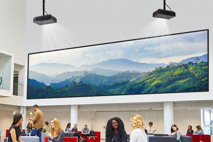 A projector in the lobby is displaying a mountain image on the wall.