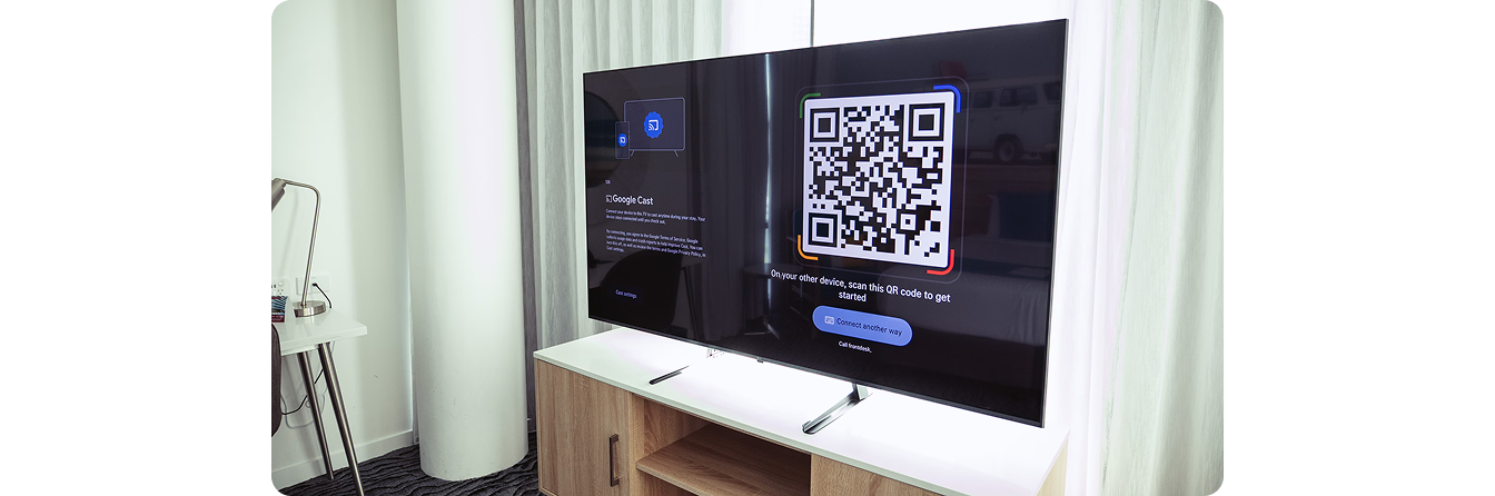 Close-up of an LG hospitality TV in a Rydges guest room showing the casting QR code for personal streaming
