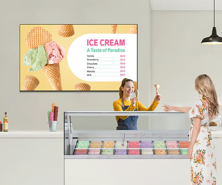 LG Professional TV displaying a vivid ice cream menu in a modern dessert shop with 4K UHD clarity. Commercial digital signage solution from LG designed to enhance customer engagement and elevate business spaces