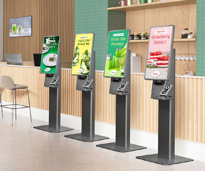 LG Kiosk self-ordering machines installed in a modern café, displaying menu options for tea and desserts. Fast and convenient LG digital kiosks enhance customer satisfaction with touch-screen ordering solutions.