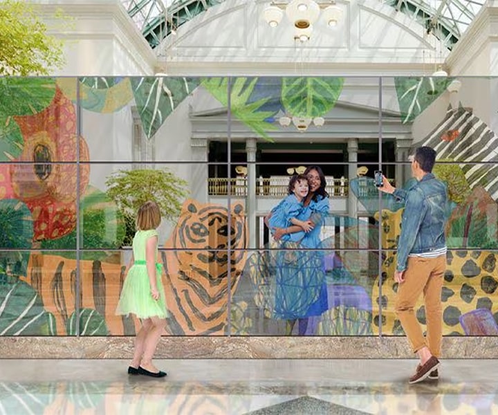 LG OLED Signage displaying a vibrant wildlife mural with lifelike colors inside a modern indoor space. Innovative LG OLED digital signage transforms customer engagement with stunning visual expression
