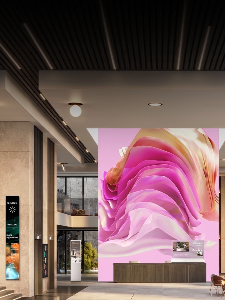 Various digital signage displays in a corporate lobby welcoming visitors with an elegant atmosphere and informative content.