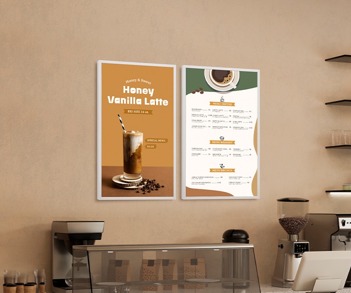 Two LG E-paper Displays are mounted on a café wall, with one displaying a beverage advertisement and the other on a menu.