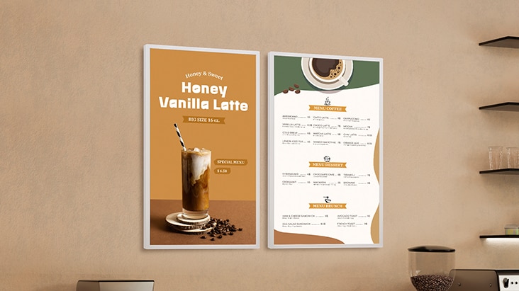 Two LG E-paper Displays are mounted on a café wall, with one displaying a beverage advertisement and the other on a menu.