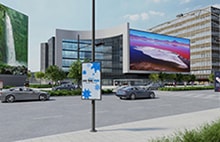 LG outdoor LED signage on city building facade showing vivid landscape visuals. LG commercial display solutions for impactful urban advertising.
