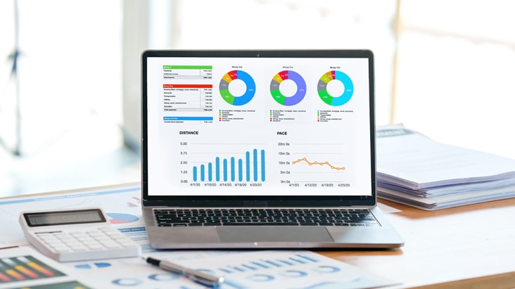 The image shows advertising performance metrics and transaction data being managed on a laptop within the Private Marketplace (PMP) environment of the Programmatic Ad feature provided by the LG DOOH Ads solution.