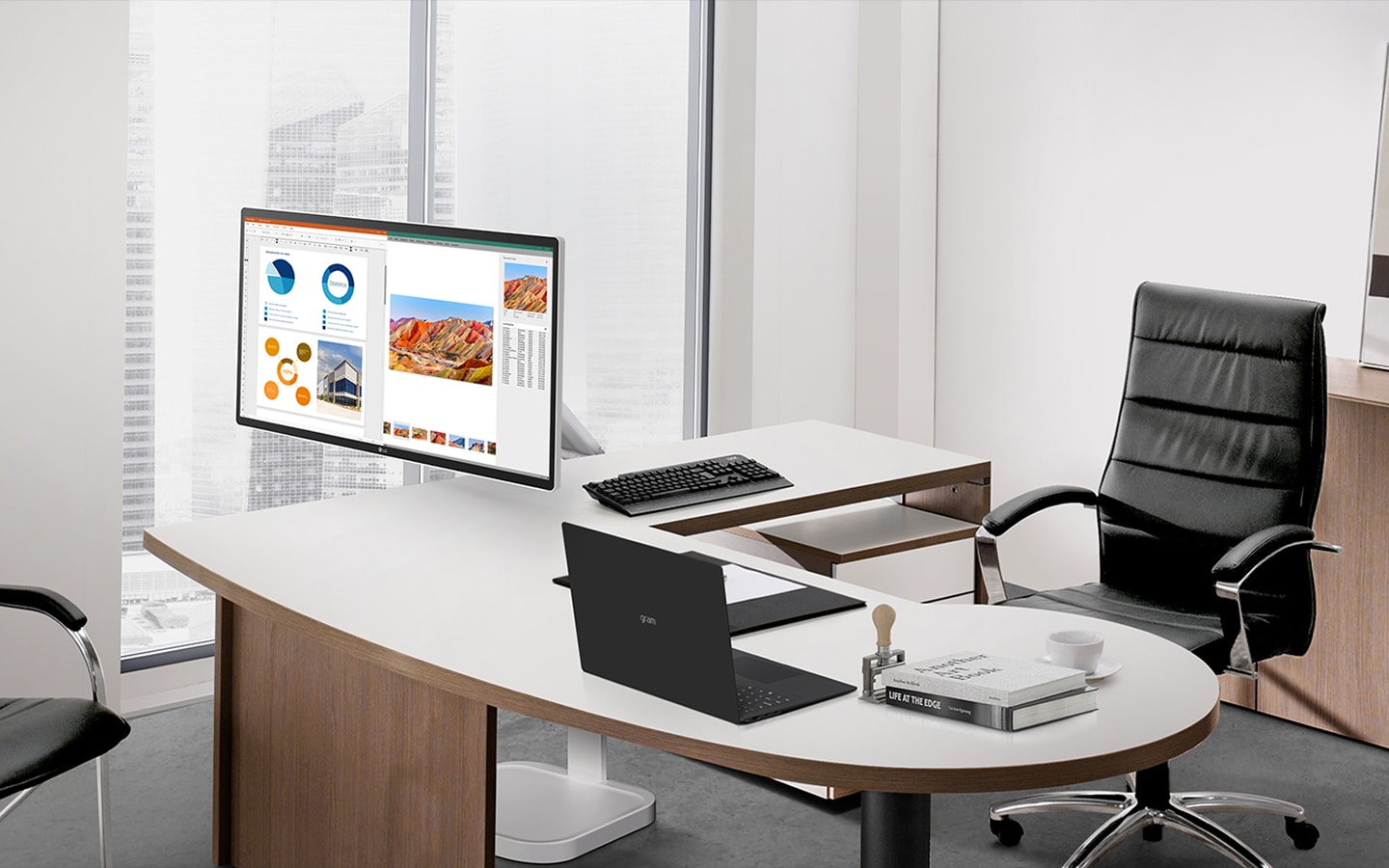 Executive office desk with monitor displaying presentation and business documents