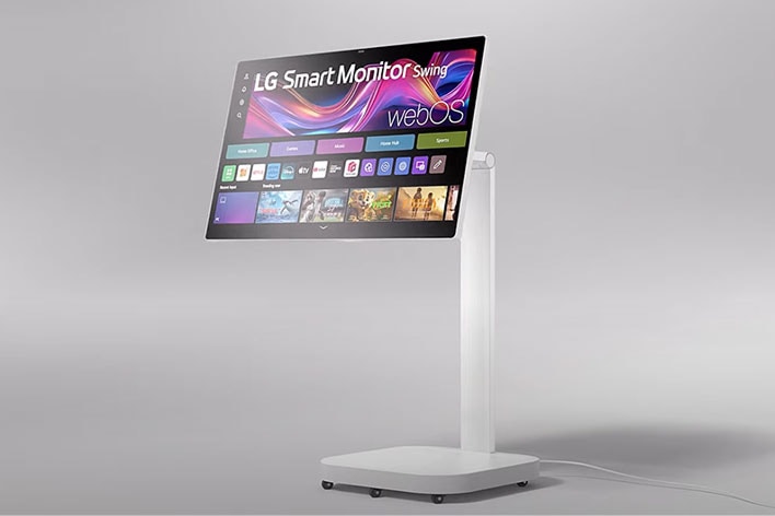LG Smart Monitor on a tall stand, showing webOS interface with multiple apps and streaming services.