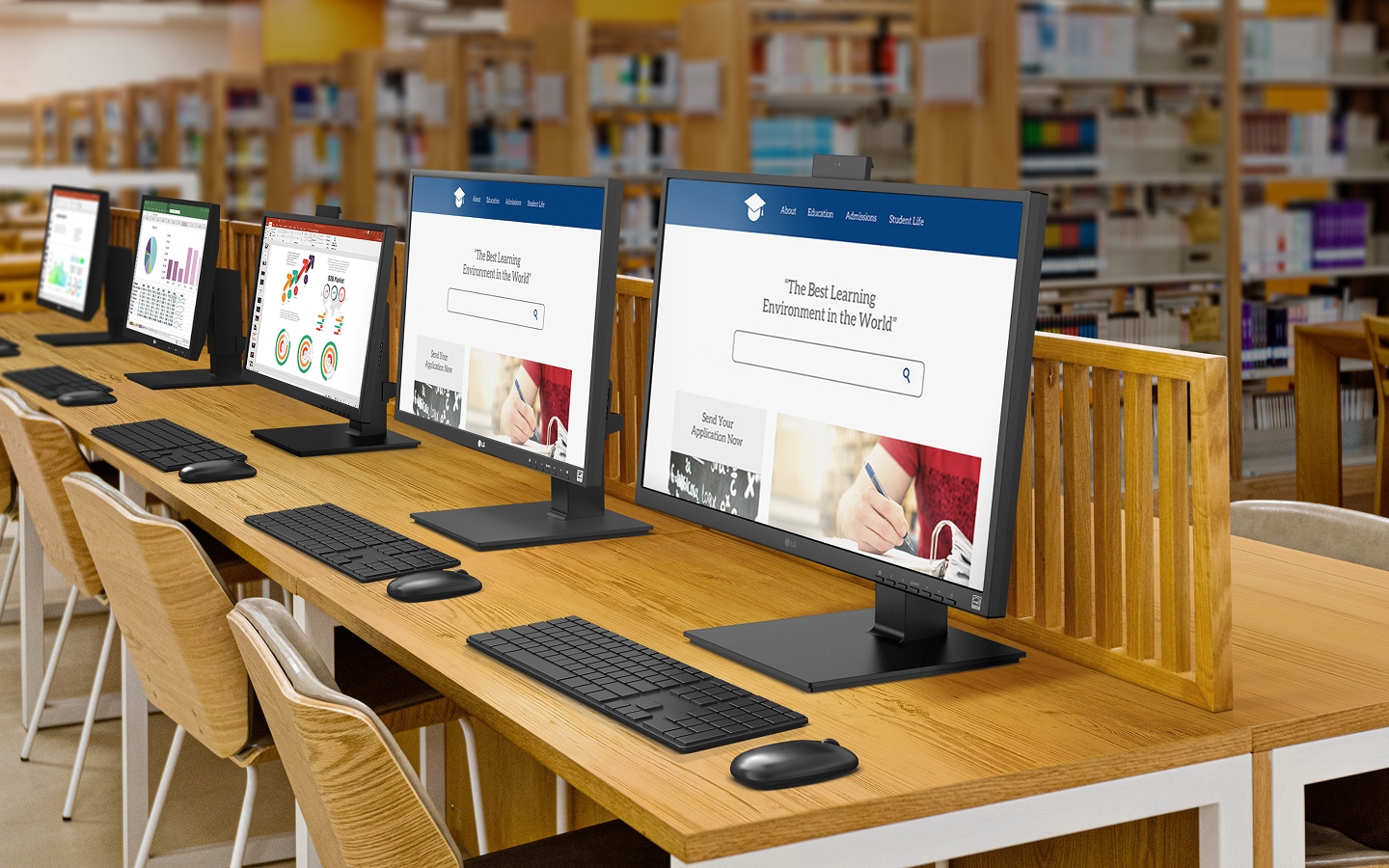 Library setting with multiple desks and monitors arranged in a row