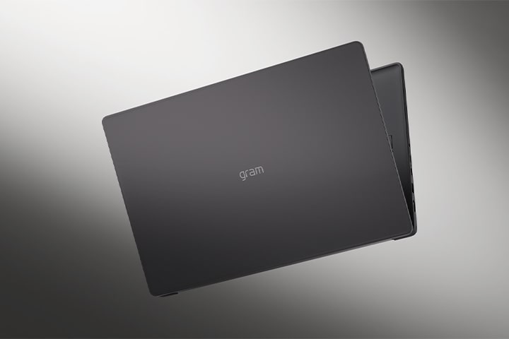 The image shows the cover of a lightweight laptop against a smooth monotone backdrop.