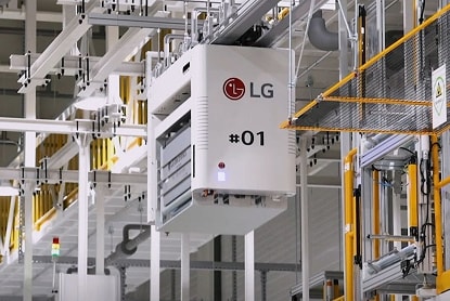 LG automated factory equipment suspended on ceiling rail inside manufacturing facility.