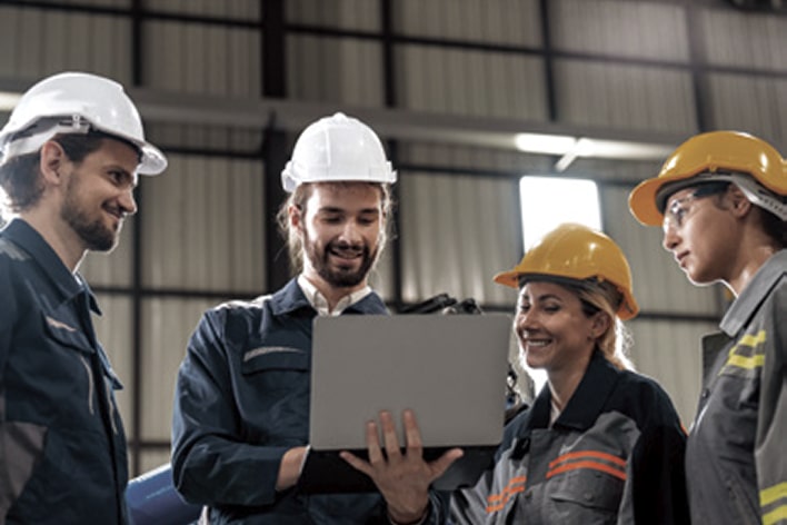 LG consultants and engineers collaborating with safety helmets, representing productivity innovation in industrial lifecycle management.