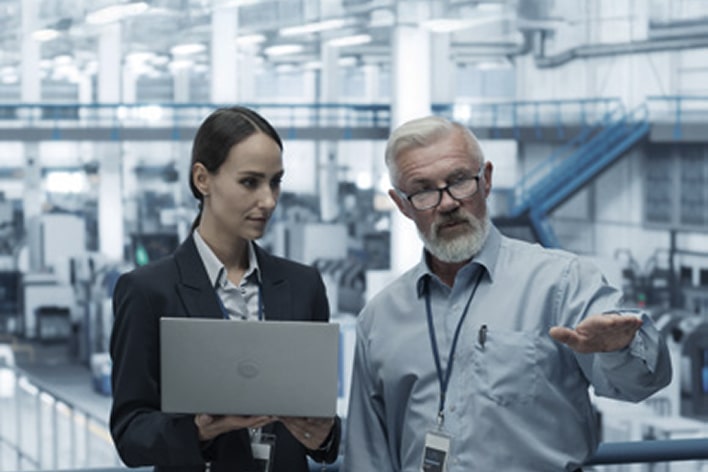 Factory experts reviewing performance metrics to ensure smooth ramp-up optimization during new production setup with LG support.