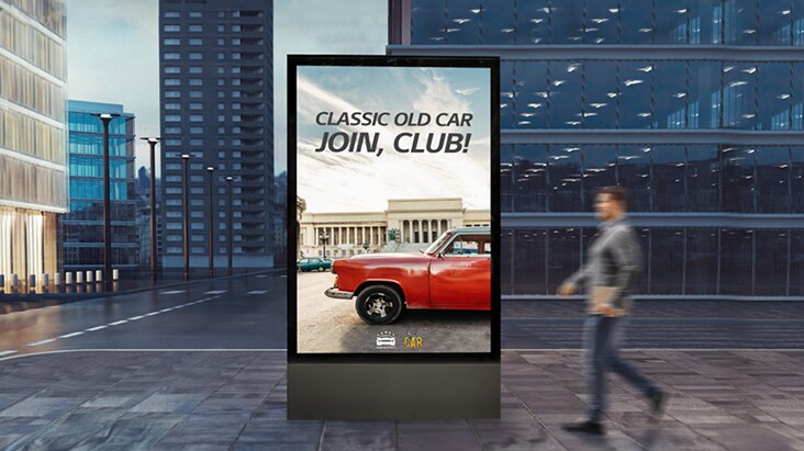 A display as tall as a person is installed at eye level on the street.