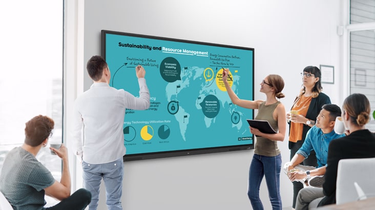In the meeting room, individuals are actively exchanging ideas by writing on the LG's interactive digital board screen at the same time.