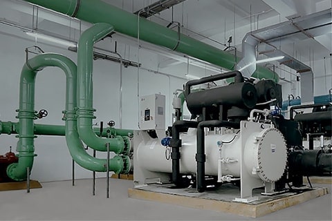 HVAC outdoor unit installed next to a modern home garage with heat pump and boiler system inside